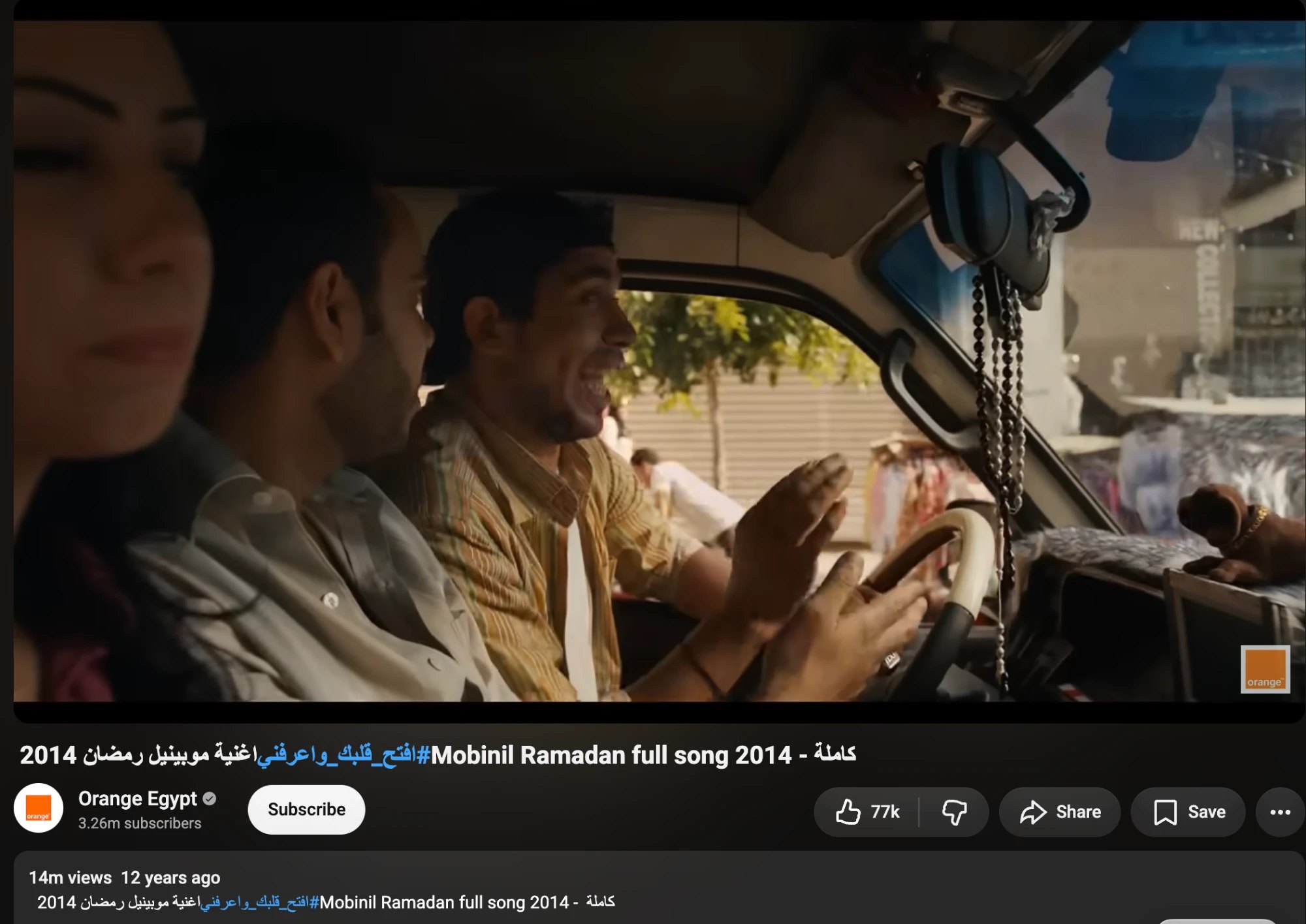 A still from the 2014 Mobinil Ramadan song, three people in a truck, one singing at the wheel.